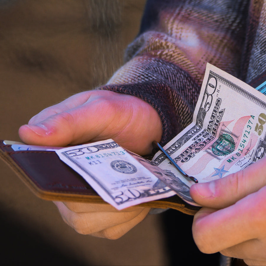 Money clip holding cash in Kamo Skinz leather wallet